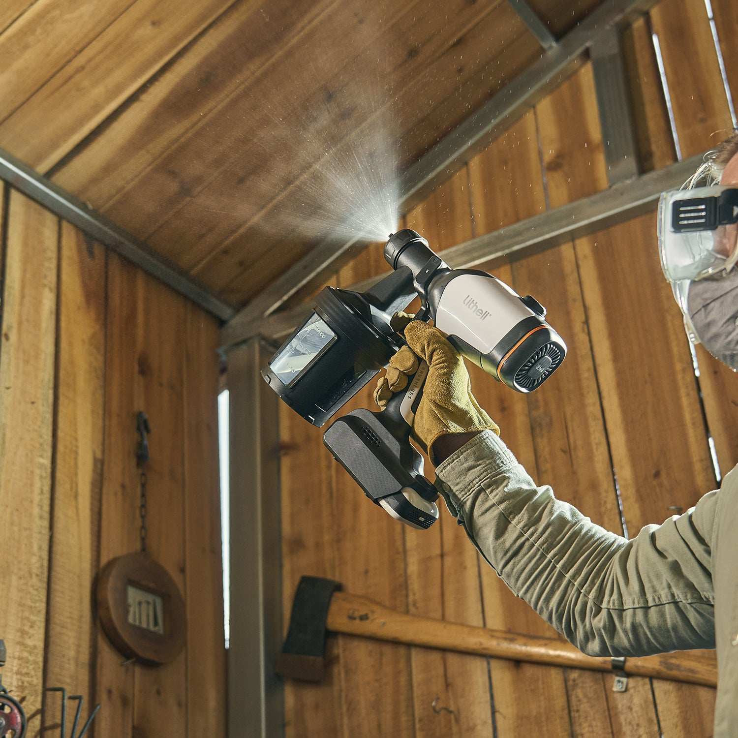 Cordless paint sprayer used for home improvement project, painting furniture and garden fences with smooth finish