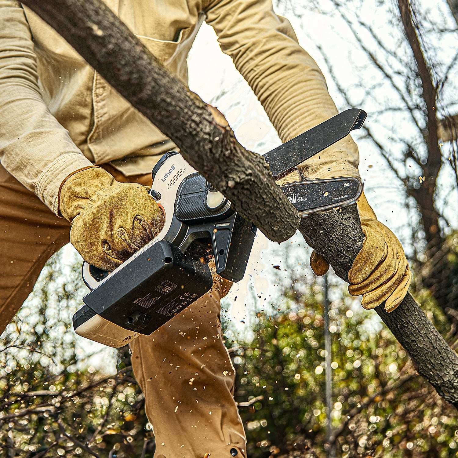 Homeowner using Litheli 20V cordless mini chainsaw for backyard tree trimming and branch cutting