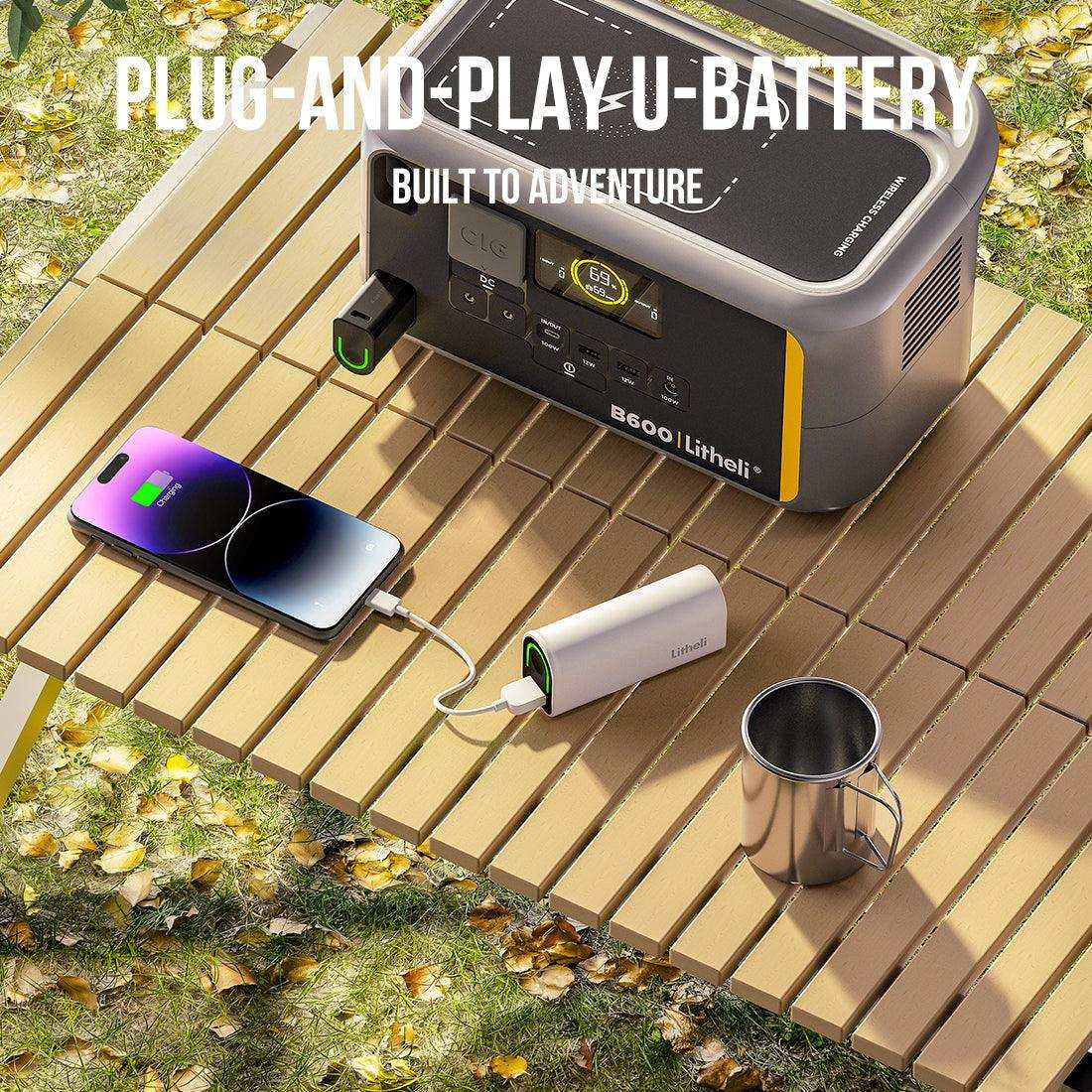 Wireless charging pad on power station charging smartphone during outdoor adventure